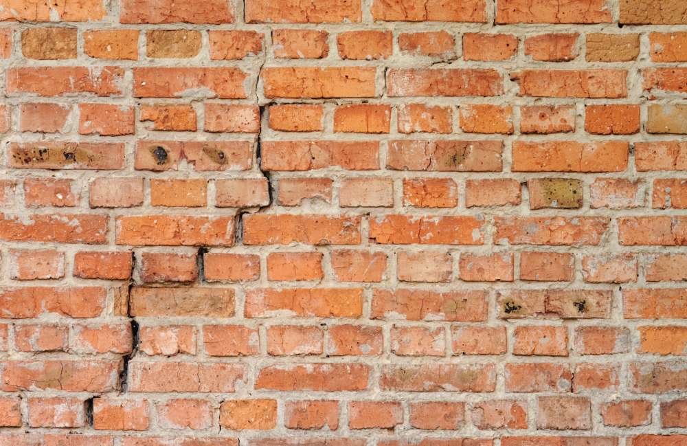 Visible crack in a brick wall during inspection